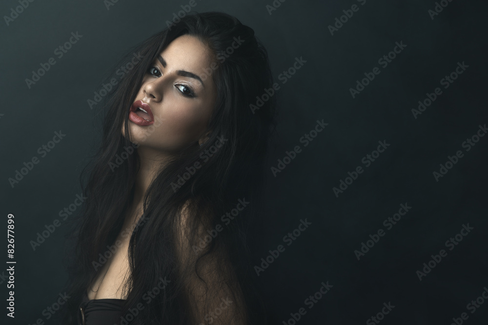 beautiful girl with tousled hair in darkness beautiful girl with tousled hair in darkness