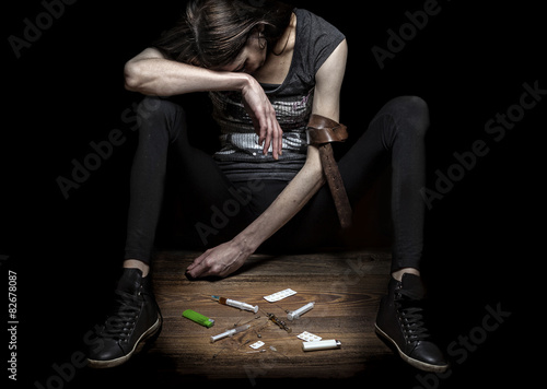 Young woman poses as drug addict. photo