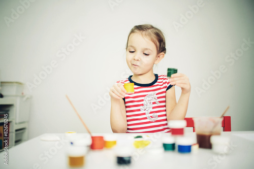 little 6 years girl with paint toy
