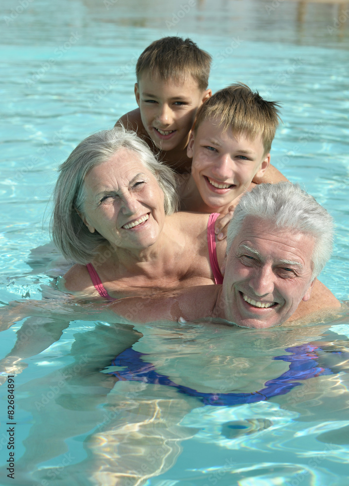 Grandparents with grandchildren in pool