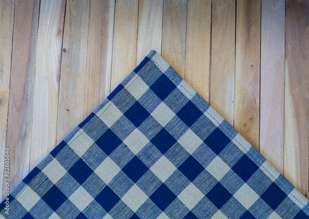 Navy Check Napkin on Wood Plank Background Navy Check Napkin on Wood Plank Background