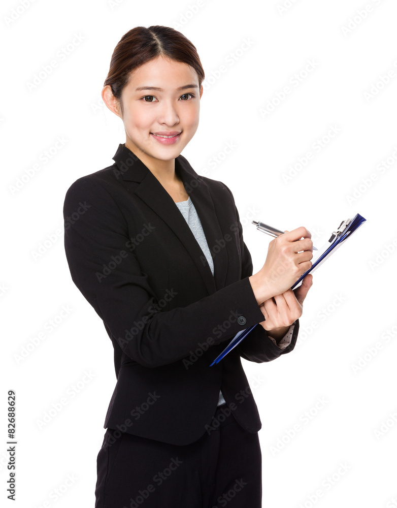 Asian young businesswoman take note on folder Asian young businesswoman take note on folder