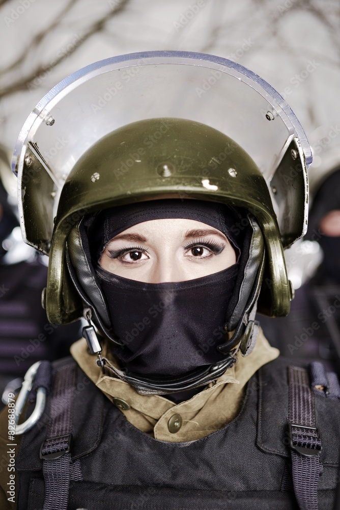 The beautiful young girl in a military uniform and a helmet The beautiful young girl in a military uniform and a helmet