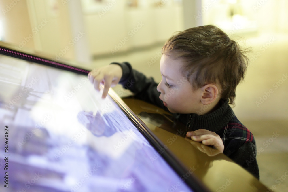 Child using touch screen Child using touch screen