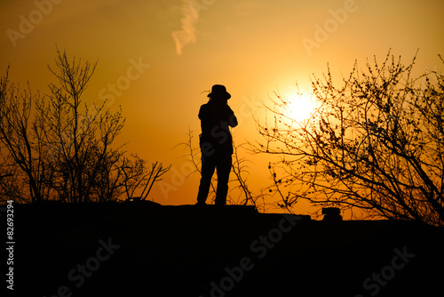traveler with sunset in dusk, climber silhouette