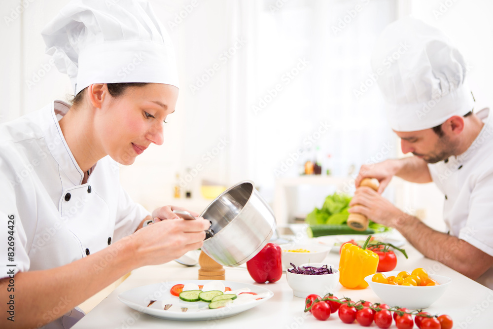 Young attractive professional chef cooking in his kitchen Young attractive professional chef cooking in his kitchen