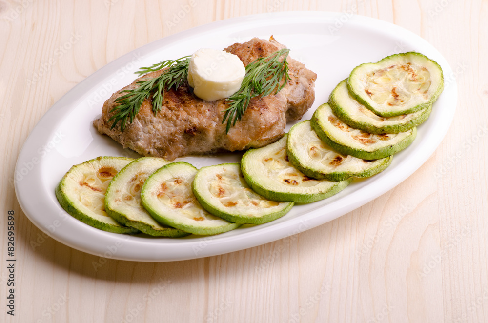 Pork steak, grilled, with melting butter and vegetables Pork steak, grilled, with melting butter and vegetables