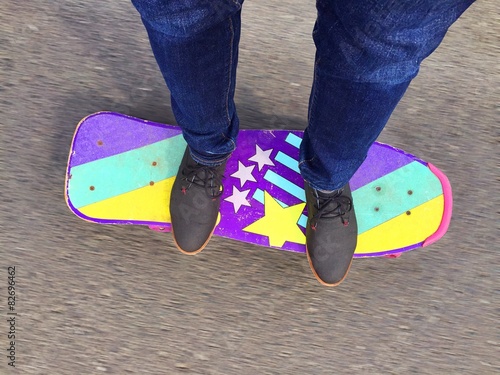 Skateboarder rides on the road photo