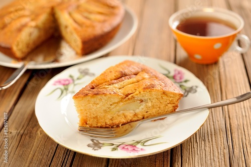 Oldfashioned apple pie with tea in orange cup