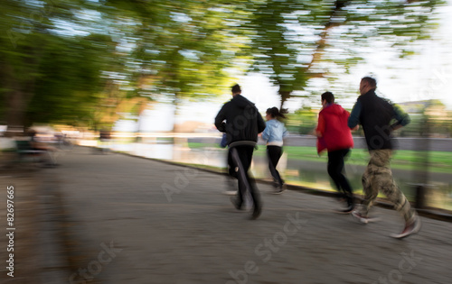 Group of runners on suburban street © vbaleha