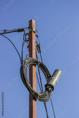 Roll of fibre optic cable with splice enclosure hanging