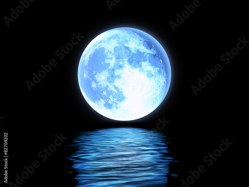 Full moon reflected in the blue water. photo
