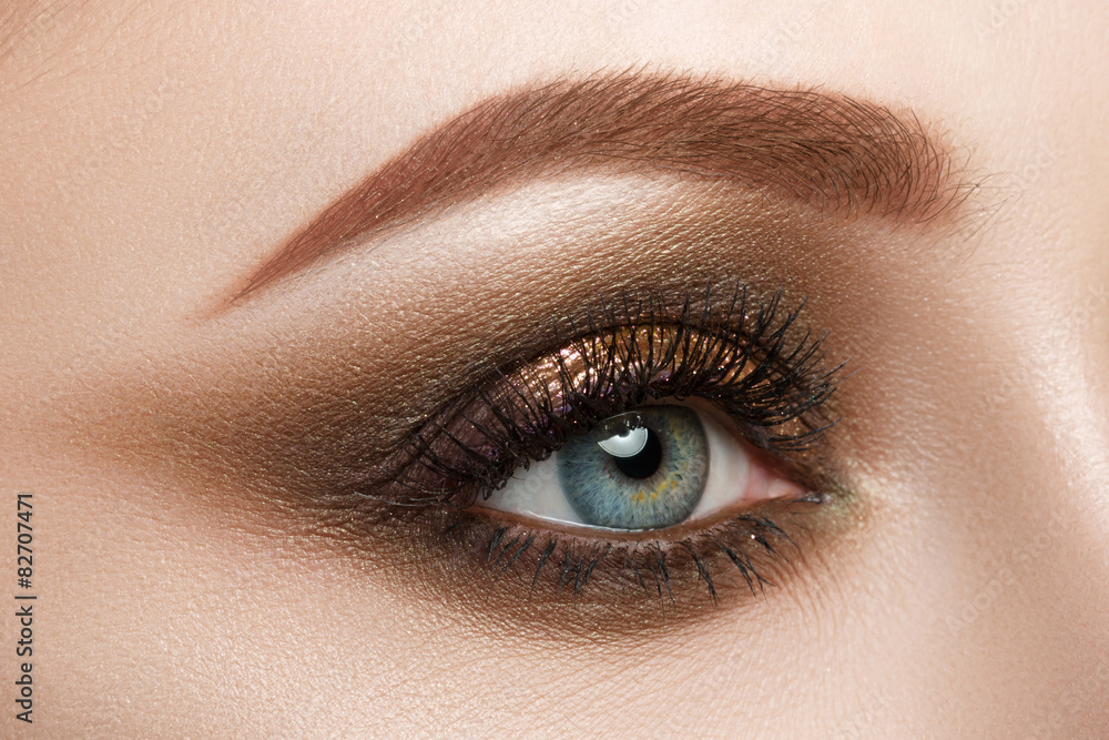 Fototapeta premium Close-up view of female blue eye with beautiful make-up