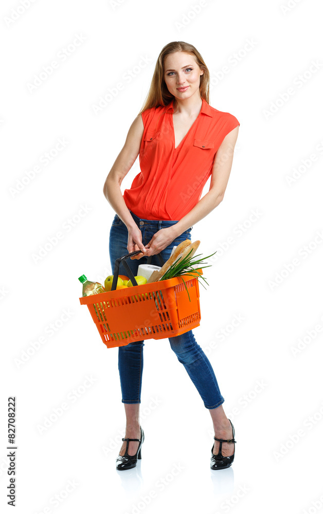 Happy young woman holding a basket full of healthy food on white Happy young woman holding a basket full of healthy food on white