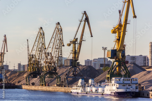 barges and cranes in river port photo