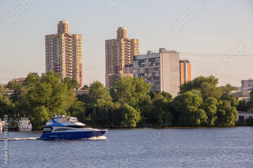 Motor boat on river in city photo