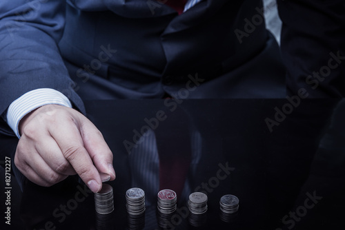 Businessman Hand Put Coins To Stack Of Coins