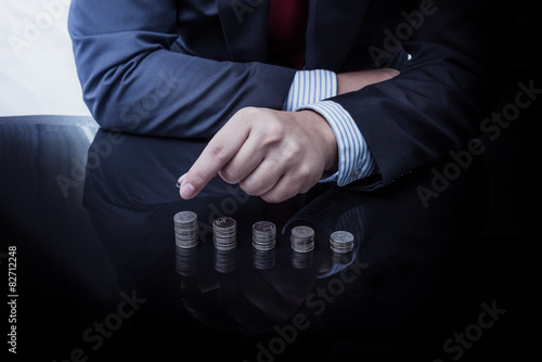 Businessman Hand Put Coins To Stack Of Coins