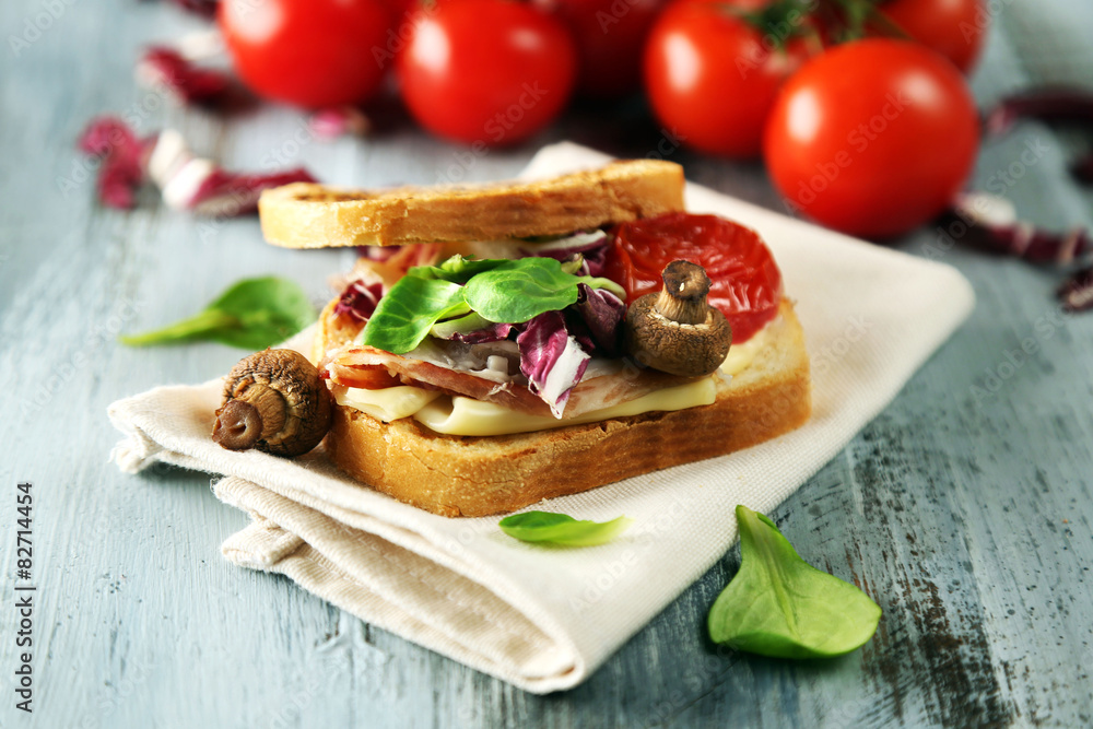 Tasty sandwich on wooden table, close up Tasty sandwich on wooden table, close up