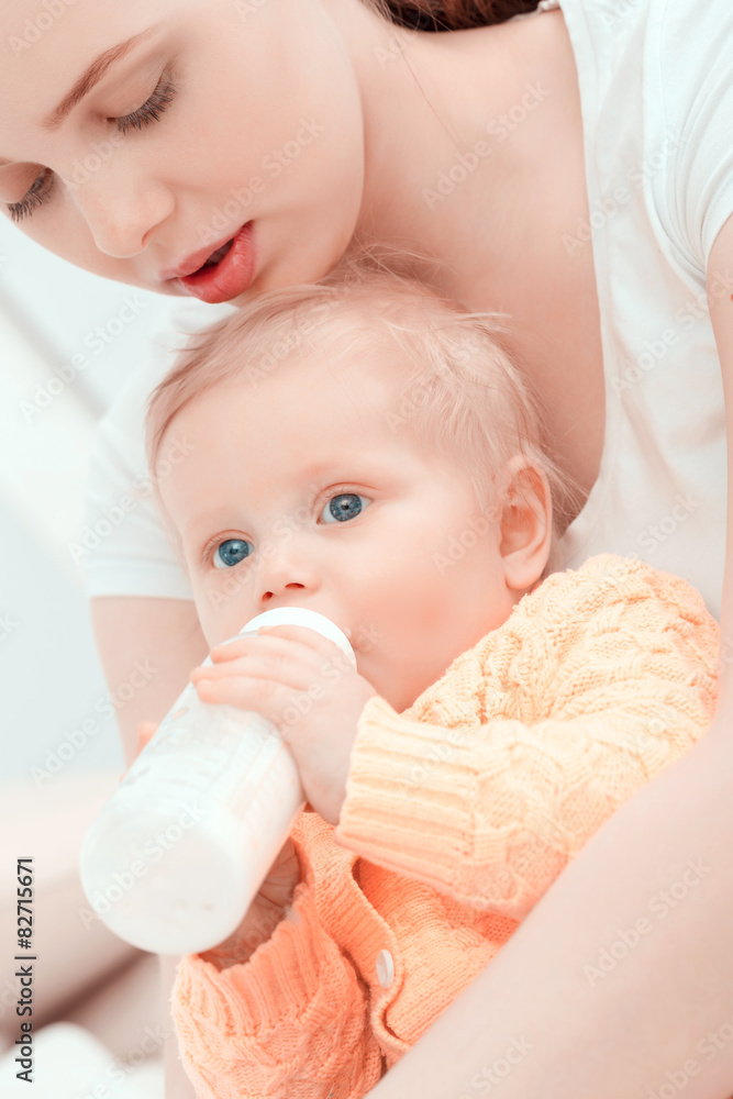 Mother and her little baby with the bottle Mother and her little baby with the bottle