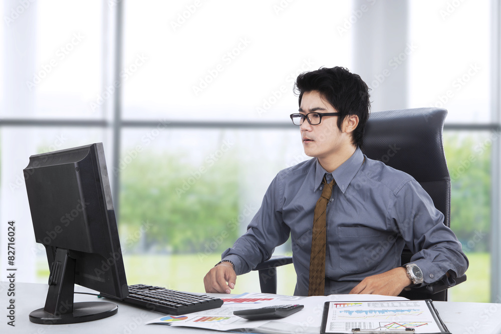 Shocked entrepreneur working near the window Shocked entrepreneur working near the window