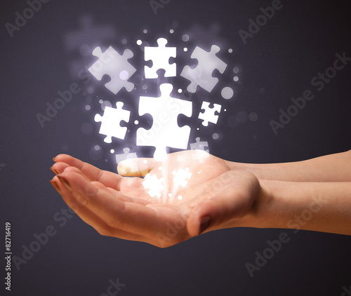 Puzzle pieces in the hand of a woman