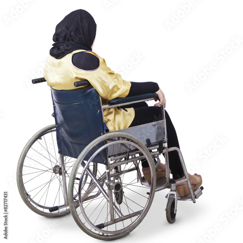 Lonely disabled woman sitting on wheelchair © Creativa Images