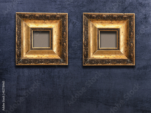 two gold frame  black wall