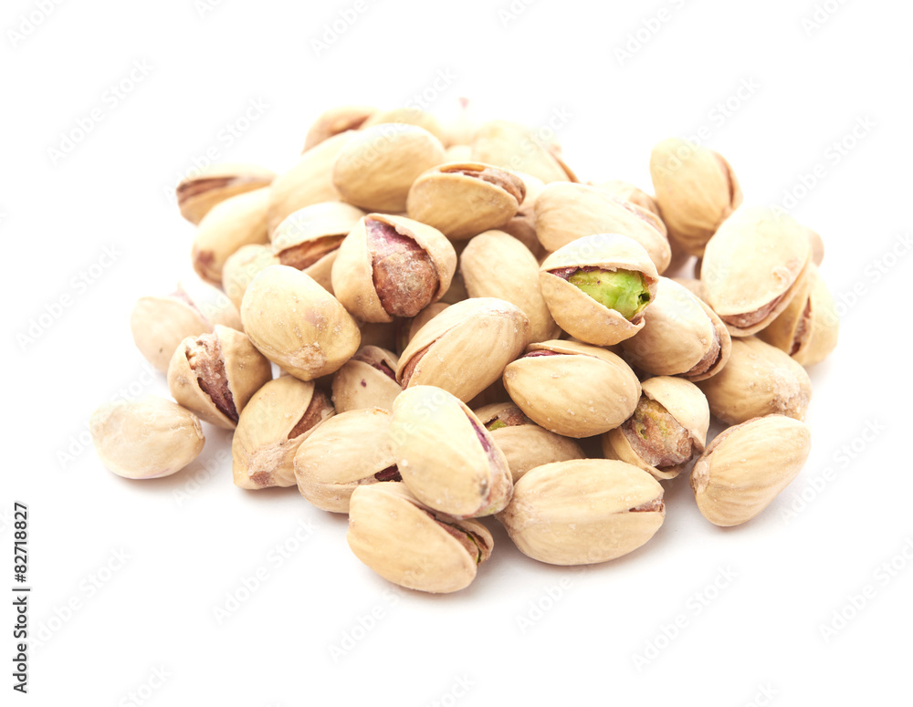 Heap of pistachios nuts isolated on the white Heap of pistachios nuts isolated on the white