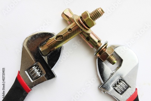 sleeve anchor bolt with spanner isolate on white background