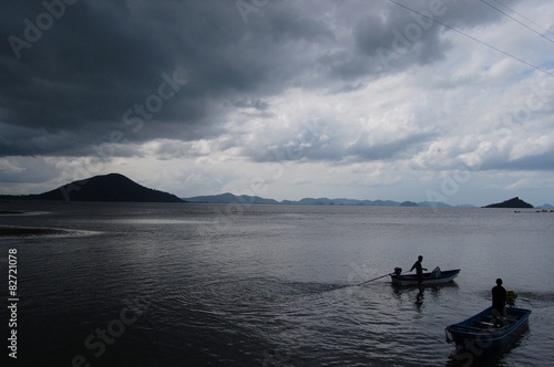 Boat floating while storm raining at Fishing village