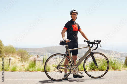  Young athletic man taking break after good cycling workout.