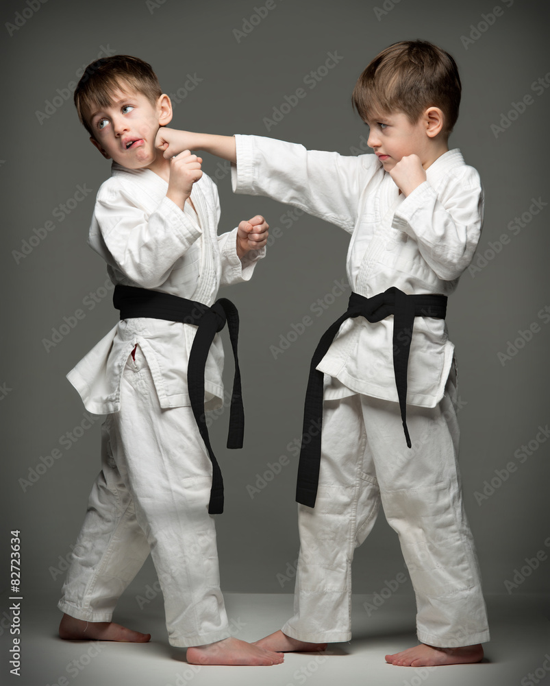 Little boys in uniform practicing judo. 