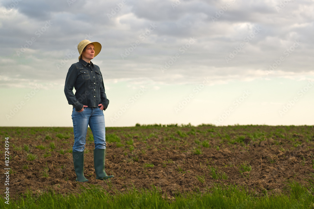 Female Farmer Standing on Fertile Agricultural Farm Land Soil