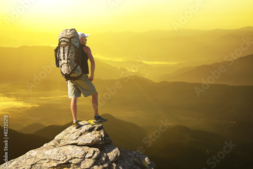 Tourist on mountain peak. Active life concept..