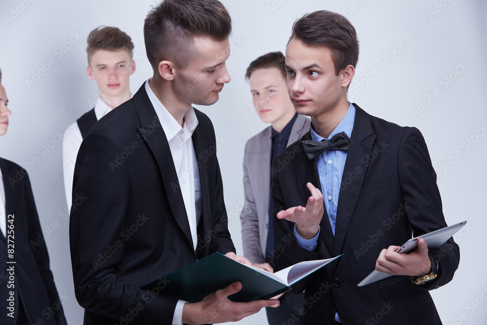 Fototapeta premium a group of young businessmen looking at paperwork