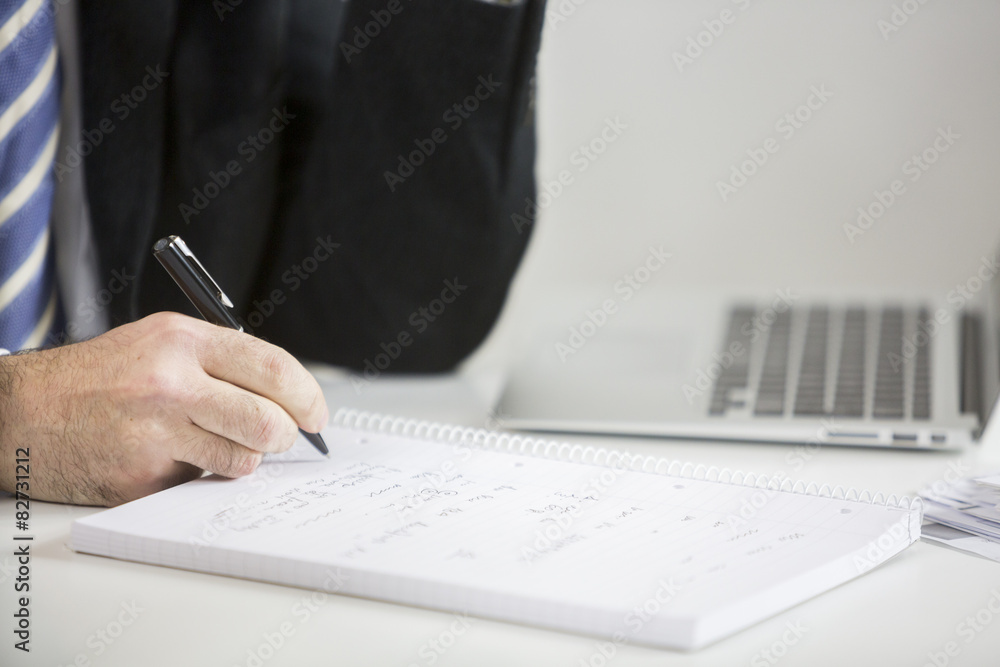Fototapeta premium Businessman's hand taking notes and planning