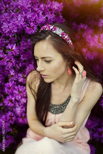 Portrait of the Summer girl in a crown, pink flowers, hot summer