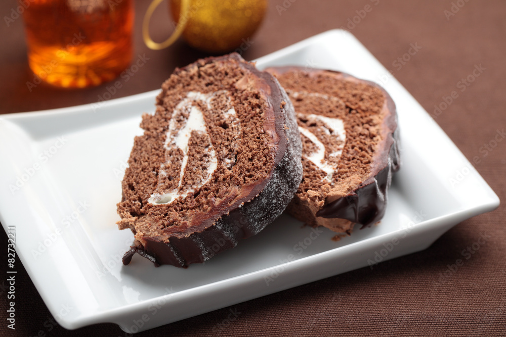 Slices of Yule log cake on a Christmas table Slices of Yule log cake on a Christmas table