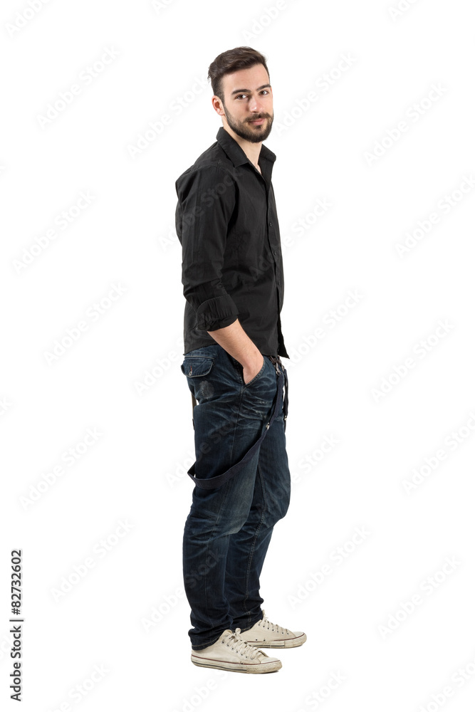 Relaxed young man side view looking at camera Relaxed young man side view looking at camera
