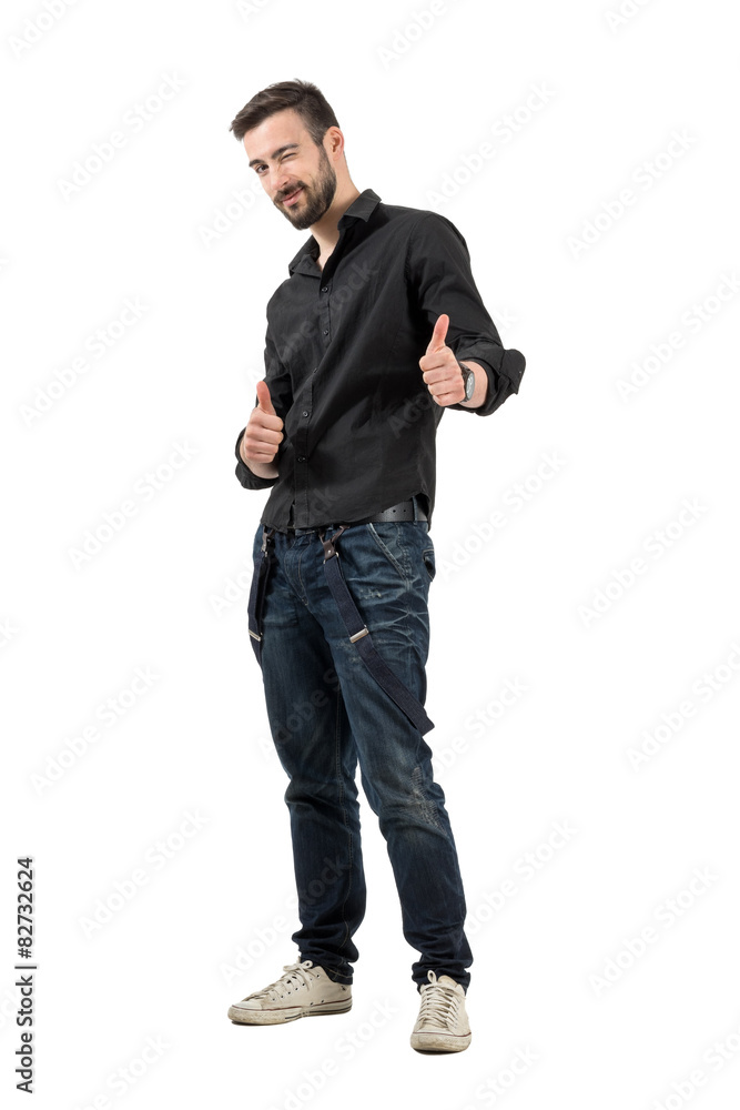 Happy smiling winking young man with thumbs up Happy smiling winking young man with thumbs up