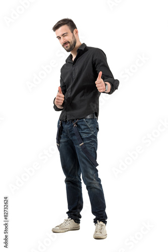 Happy smiling winking young man with thumbs up