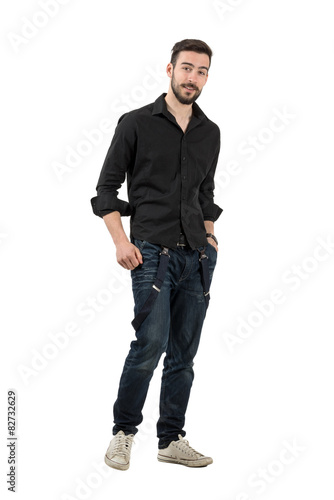 Young man in black shirt with rolled up sleeves walking isolated