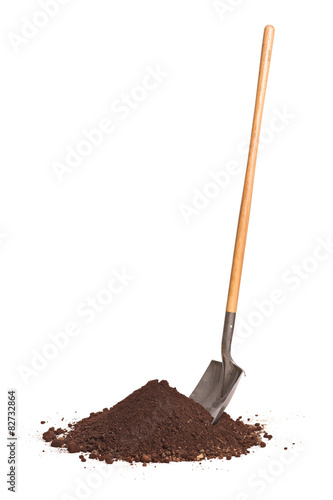 Vertical shot of shovel stuck in a pile of dirt photo