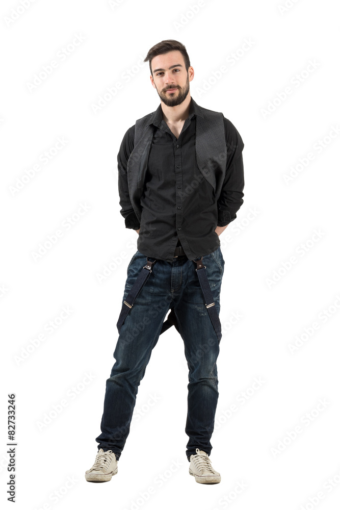 Confident young male fashion model with hands on his back Confident young male fashion model with hands on his back