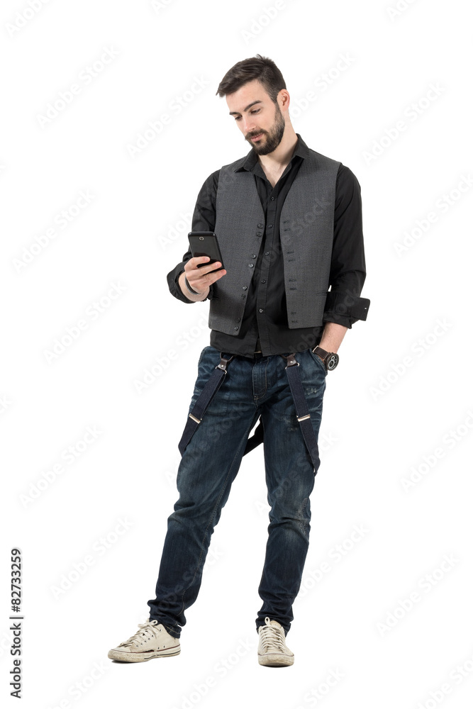 Young trendy man reading message on his cellphone. Young trendy man reading message on his cellphone.