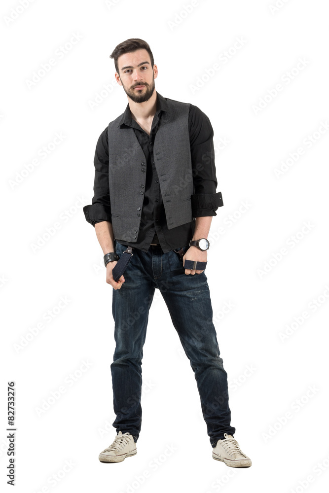 Young male fashion model holding his suspenders isolated Young male fashion model holding his suspenders isolated
