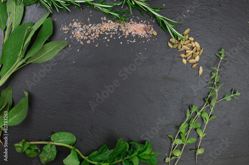 aromatic herbs over black slate