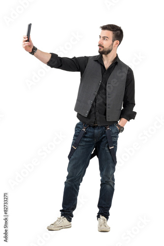 Trendy young man taking selfie photo with his mobile phone
