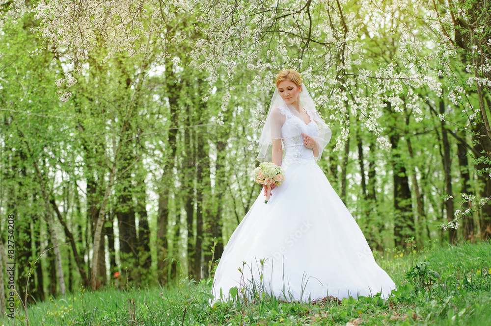 Beautiful bride in wedding dress and bridal bouquet